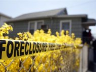 Police tape marked as a Foreclosure Free Zone is seen outside the foreclosed home of Marie Elie in Elmont