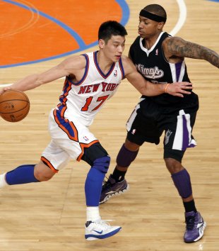 Knicks' Lin drives into Kings' Thomas during third quarter of their NBA basketball game in New York