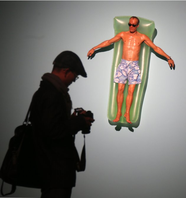 A visitor walks past a sculpture entitled "Drift"  by artist Ron Mueck during his exhibition at the Fondation Cartier pour l'art contemporain in Paris