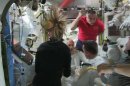 In this image from video made available by NASA, astronauts discuss the aborted spacewalk aboard the International Space Station on Tuesday, July 16, 2013. A dangerous water leak in the helmet of Luca Parmitano, bottom center facing camera in white suit, drenched his eyes, nose and mouth, preventing him from hearing or speaking as what should have been a routine spacewalk came to an abrupt end. (AP Photo/NASA)