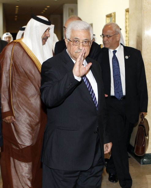 Palestinian President Mahmoud Abbas gestures as he arrives to the Arab Peace Initiative Committee Meeting in Doha