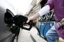 A customer fills a car's tank at a gas station approximately one mile from the White House in Washington