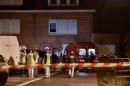 Emergency services workers stand outside the house (R) where five members of the same family were found dead on October 21, 2015 in Haubourdin, in the suburbs of Lille, according to police sources