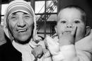 Mother Teresa holds Christina Ott during a signing ceremony