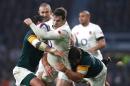 England's Elliot Daly (C) is tackled by South African players during their rugby union Test match, at Twickenham stadium in south-west London, on November 12, 2016
