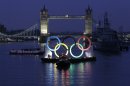 Backdropped by the historic Tower Bridge, a giant Olympic Rings floats on the River Thames in London in the run-up for the Olympic games, during its launch to mark 150-days until the start of the London 2012 Olympic games, Tuesday, Feb. 28, 2012. (AP Photo/Sang Tan)