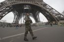 A French soldiers patrols infront of the Eiffel tower, Sunday, Jan. 13, 2013. France has ordered tightened security in public buildings and transport following action against radical Islamists both in Mali and Somalia, French President Francois Hollande said yesterday. (AP Photo/Michel Euler)