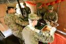 U.S. soldiers serve food to fellow soldiers as they celebrate Thanksgiving Day inside the U.S. army base in Qayyara, south of Mosul