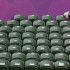 A spectator sits amid empty seats at the All England Lawn Tennis Club during the women's singles match between Denmark's Wozniacki and Great Britain's Keothavong at the London 2012 Olympics Games