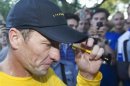 Lance Armstrong walks back to his car after running at Mount Royal park with fans in Montreal