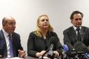 Suha Arafat, center, flanked with her French Lawyer Pierre Olivier Sur, right, and International Lawyer Saad Djebbar during a press conference in Paris, France, Tuesday , Dec. 3, 2013. Palestinian leader Yasser Arafat's widow says extensive investigation by French scientists has ruled out poisoning by radioactive polonium. Scientists from several countries have tried to determine what killed Arafat and whether polonium played a role. He died in a French military hospital in 2004. Palestinians have long suspected Israel of poisoning him, which Israel denies. Suha Arafat told reporters in Paris on Tuesday that the French scientists' report excludes the possibility of polonium poisoning. That's in contrast to a recent Swiss lab report that said Arafat was probably poisoned by polonium, a rare and extremely lethal substance. Suha Arafat said she's "upset by these contradictions by the best European experts on the matter." The French report is part of an ongoing French legal investigation into whether Arafat was murdered.(AP Photo/Jacques Brinon)