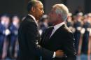 U.S. President Barack Obama hugs outgoing Defense Secretary Chuck Hagel during a farewell ceremony at Joint Base Myer-Henderson Hall in Virginia,