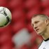 Germany's national soccer player Schweinsteiger looks at the ball during a training session at the stadium in Warsaw