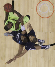 Baylor's Logan Lowery (20) shoots under pressure from Xavier's Tu Holloway (52) and Xavier's Travis Taylor right during the first half of an NCAA South Regional semifinal college basketball tournament game Friday, March 23, 2012, in Atlanta. (AP Photo/David J. Phillip)
