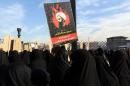 Iranian women gather during a demonstration against the execution of prominent Shiite Muslim cleric Nimr al-Nimr (portrait) by Saudi authorities, at Imam Hossein Square in the capital Tehran on January 4, 2016