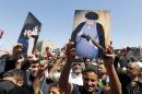 Supporters of prominent Iraqi Shi'ite cleric Moqtada al-Sadr shout slogans during a protest against government corruption after Friday prayers in Baghdad's Sadr City