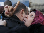 Libyans react to the death of Moammar Gadhafi outside the Libyan Embassy in London, Thursday, Oct. 20, 2011. (AP Photo/Sang Tan)