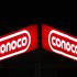FILE - In this Oct. 25, 2011 file photo, a Conoco sign shines in Dallas. Higher oil prices are making it easier for ConocoPhillips to complete a massive transformation this year. (AP Photo/LM Otero, File)