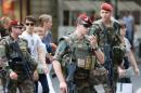 French soldiers, part of "Operation Vigipirate", patrol near the Galeries Lafayette in Paris on July 15, 2016, a day after the attack in Nice