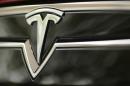 A Tesla Motors logo is shown on a Tesla Model S at a Tesla Motors dealership at Corte Madera Village, an outdoor retail mall, in Corte Madera