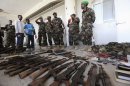 Somali National Army and members of AMISOM display ammunitions and explosives recovered from Islamist al Shabaab militants in Somalia's capital Mogadishu