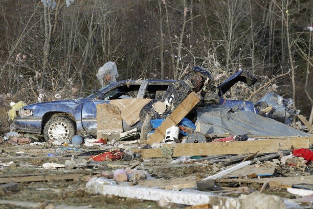 A wrecked car is seen amid debris following a tornado where several people died, in East Bernstadt, Kentucky