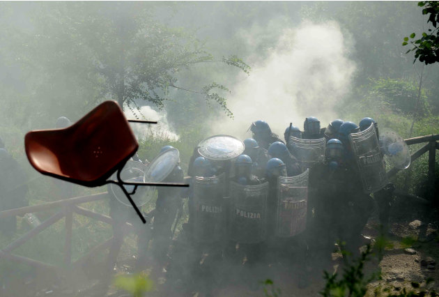 Italian police officers in riot gear clash with demonstrators during a protest against proposed plans to build the Turin-Lyon high-speed train line and a tunnel in the Italian "Val di Susa" valley, in
