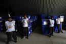 Afghan election commission stand by before preparing to send ballot boxes and election material to the polling stations at a warehouse in Kabul