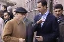 In this image made from video, Syrian President Bashar Assad, second right, visits Baba Amr neighborhood in Homs, Syria, Tuesday, March 27, 2012. Assad visited Baba Amr, a former rebel stronghold in the key city of Homs that became a symbol of the uprising after a monthlong siege by government forces killed hundreds of people many of them civilians as troops pushed out rebel fighters. Homs has been one of the cities hardest hit by the government crackdown on the uprising that began last March. (AP Photo/Syrian State Television via APTN) SYRIA OUT TV OUT