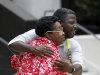 Rebecca Glover, aunt of a victim of a separate civil rights case against New Orleans police officers, hugs supporters of victims and their families outside Federal Court after five current or former police officers were convicted in the deadly shootings on a New Orleans bridge after Hurricane Katrina, in New Orleans, Friday, Aug. 5, 2011. Former officer Robert Faulcon, Sgts. Robert Gisevius and Kenneth Bowen, Officer Anthony Villavaso and retired Sgt. Arthur Kaufman were convicted of charges stemming from the cover-up of the shootings. All but Kaufman were convicted of civil rights violations stemming from the shootings. Kaufman, who investigated the shootings, was charged only in the cover-up. (AP Photo/Gerald Herbert)