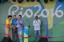 L-R: Bazilian former basketball player and Mayor of the Olympic Village, Janeth Arcain, President of the Brazilian Olympic Committee Carlos Nuzman and Rio de Janeiro's Mayor Eduardo Paes cut the ribbon during opening ceremony of the Olympic Village