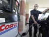 FILE - Nov. 8, 2011 file photo, Yuri Godin, of Charlotte, N.C., pumps gas at a Costco in Matthews, N.C. Costco Wholesale Corp. said Thursday, Feb. 2, 2012, that revenue at stores open at least a year climbed 8 percent in January, helped by higher gas prices. (AP Photo/Chuck Burton, File)