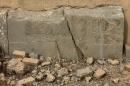 A part of carved stone slabs which were destroyed by the Islamic State militants, is seen at the ancient site of Nimrud some 19 miles (30 kilometers) southeast of Mosul, Iraq, Wednesday, Nov. 16, 2016. The late 1980s discovery of treasures in Nimrud's royal tombs was one of the 20th century's most significant archaeological finds. The government said the IS militants, who captured the site in June 2014, destroyed it the following year, using heavy military vehicles. (AP Photo/Hussein Malla)