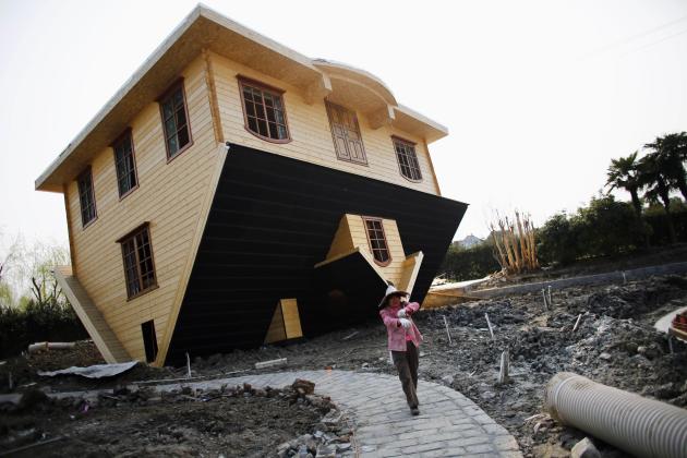 A labourer works at an upside-down house under construction at Fengjing Ancient Town, Jinshan District