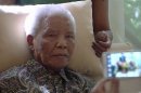 In this image taken from video, the ailing anti-apartheid icon Nelson Madela is filmed Monday April 29, 2013, more than three weeks after being released from hospital. Mandela was treated in hospital for a recurring lung infection. South African President Jacob Zuma visited the former leader on Monday, but Mandela does not appear to speak during the televised portion of the visit, as he sits in an armchair, his head propped up by a pillow with his cheeks showing what appear to be marks from a recently removed oxygen mask, although Zuma said he found Nelson Mandela 