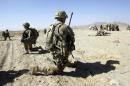U.S. Army soldiers of 2nd Battalion, 1st Infantry Regiment take up positions while Afghan soldiers search motorists, during a joint U.S.-Afghan military patrol in a village in Arghandab Valley in Kandahar province