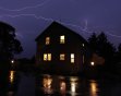 Lightning streaks across the sky above a home Tuesday, June 21, 2011, in Saukville, Wis.  (AP Photo/Jeffrey Phelps)
