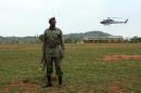 A soldier keeps watch as a helicopter lands in Catandica on October 29, 2013