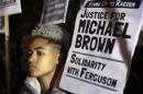 A demonstrator takes part in a protest to show solidarity with the family of black teenager Michael Brown, outside the American Embassy in London