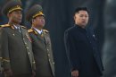 In this April 13, 2012 photo, North Korean leader Kim Jong Un stands next to senior military leaders during a ceremony in honor of his father, Kim Jong Il and grandfather, Kim Il Sung in Pyongyang. In very different ways, North Korea, run by the same family as a Stalinist dictatorship since the 1940s, and Myanmar, run by a cabal of generals, have opened themselves up over the past year or so, allowing the world to peer behind the political curtains they had so laboriously erected, but the question of whether there has been any real change still remains. (AP Photo/David Guttenfelder)