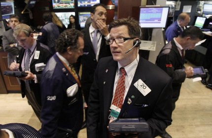 Trader Christopher Forbes foreground right, watches prices as he works on the floor of the New York Stock Exchange Thursday, Aug. 18, 2011. (AP Photo/Richard Drew)