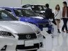 A couple walk by Lexus models displayed at a Toyota Motor Corp. showroom in Tokyo Monday, Nov. 5, 2012. Toyota's quarterly profit tripled, driven by a recovery from natural disasters, and the company raised its full-year earnings forecast despite a sales slump in China. (AP Photo/Koji Sasahara)