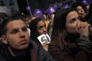 Supporters of the Podemos party wait for the final official election results in Madrid, Sunday, Dec. 20, 2015. A strong showing by upstart parties Podemos and Ciudadanos is threatening to upend the country's traditional two-party system in Spain's general election, with exit polls and early results projecting that the ruling Popular Party won the most votes but fell far short of a parliamentary majority and risks being booted from power.(AP Photo/Daniel Ochoa de Olza)