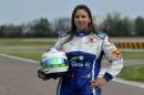 Simona De Silvestro, of Switzerland, poses prior to a training session at Ferrari's Fiorano test track, near Modena, Italy, Saturday, April 26, 2014. Simona de Silvestro is an affiliated driver with Sauber this year with a goal of competing for a Formula One seat in 2015. The Swiss driver has spent the last four years racing in IndyCar, and scored her first career podium in October with a second-place finish at Houston. It was the first podium finish for a woman on a road course in IndyCar. The 25-year-old De Silvestro has been spending this year testing, participating in simulator training and preparing for the mental and physical demands of F1. Sauber says the goal is to help De Silvestro earn her F1 super license and prepare for a seat in 2015. (AP Photo/Marco Vasini)