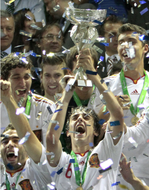 Spain's team celebrates with the trophy after winning the UEFA European Under-19 Championship in Chiajna, Romania, Monday night, Aug. 1, 2011. Spain defeated the Czech Republic in the final 3-2 after extra time. (AP Photo/Vadim Ghirda)