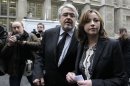 Singer Charlotte Church, right, leaves the High Court in London after hearing the reading of a statement setting out the terms of the settlement for phone hacking damages claim against News International, Monday, Feb. 27, 2012. Church, who testified before a media inquiry of being hounded by Rupert Murdoch's journalists when she was a teen singing sensation, received 600,000 pounds ($951,000) Monday in a phone hacking settlement from News International and said she had been sickened by what she had learnt about intrusion into her private life. (AP Photo/Sang Tan)