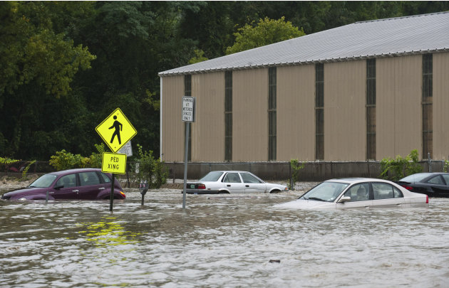 Cars in the parking lot at the bottom of Canal St. are submerged nearly to their windows by the flooding Whetstone Brook in Brattleboro, Vt. on Sunday, Aug. 28, 2011. The remnants of Hurricane Irene d
