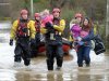 Crew Commander from Tewkesbury fire station Dave Webb carries 19-month-old daughter of Tina Bailey who carries her 3 year old daughter, after they were rescued from their house in Gloucester, England, Tuesday Nov. 27, 2012. Thousands of drivers and residents face further chaos today after heavy rain continued to fall across Britain overnight. (AP Photo/PA, Tim Ireland) UNITED KINGDOM OUT  NO SALES  NO ARCHIVE