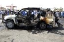 Police investigate the site of a car explosion at the city of Port Sudan