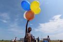 A Rohingya child plays with balloons at a temporary shelter in Kuala Cangkoi, Lhoksukon, Aceh province, Indonesia